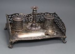 A Victorian silver inkstand with pierced three quarter gallery, two wells, taperstick and pen