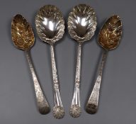 Two George III silver 'berry' spoons and a later pair of ornate silver serving spoons by Walker &