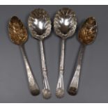 Two George III silver 'berry' spoons and a later pair of ornate silver serving spoons by Walker &