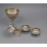A pair of Victorian silver bun salts, a silver napkin ring and a modern silver goblet.