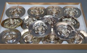 Fourteen assorted Garrard & Co Ltd modern silver novelty circular dishes, each with central figure