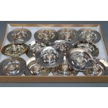 Fourteen assorted Garrard & Co Ltd modern silver novelty circular dishes, each with central figure