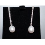 A pair of 750 white metal, diamond and cultured pearl line drop earrings, 35mm.