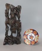 A Chinese carved hardwood figure of a warrior and an Imari plate height 46cm