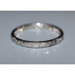 A white metal and diamond set full eternity ring, size R.