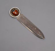 A continental 935 white metal and three colour enamel bookmark, decorated with a lady bird, 74mm.