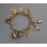 A 9ct gold charm bracelet with padlock clasp and 11 charms, gross 18.2 grams.