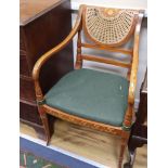 A pair of Sheraton design satinwood elbow chairs