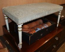 A rectangular stool with upholstered seat on painted ring-turned supports W.92cm