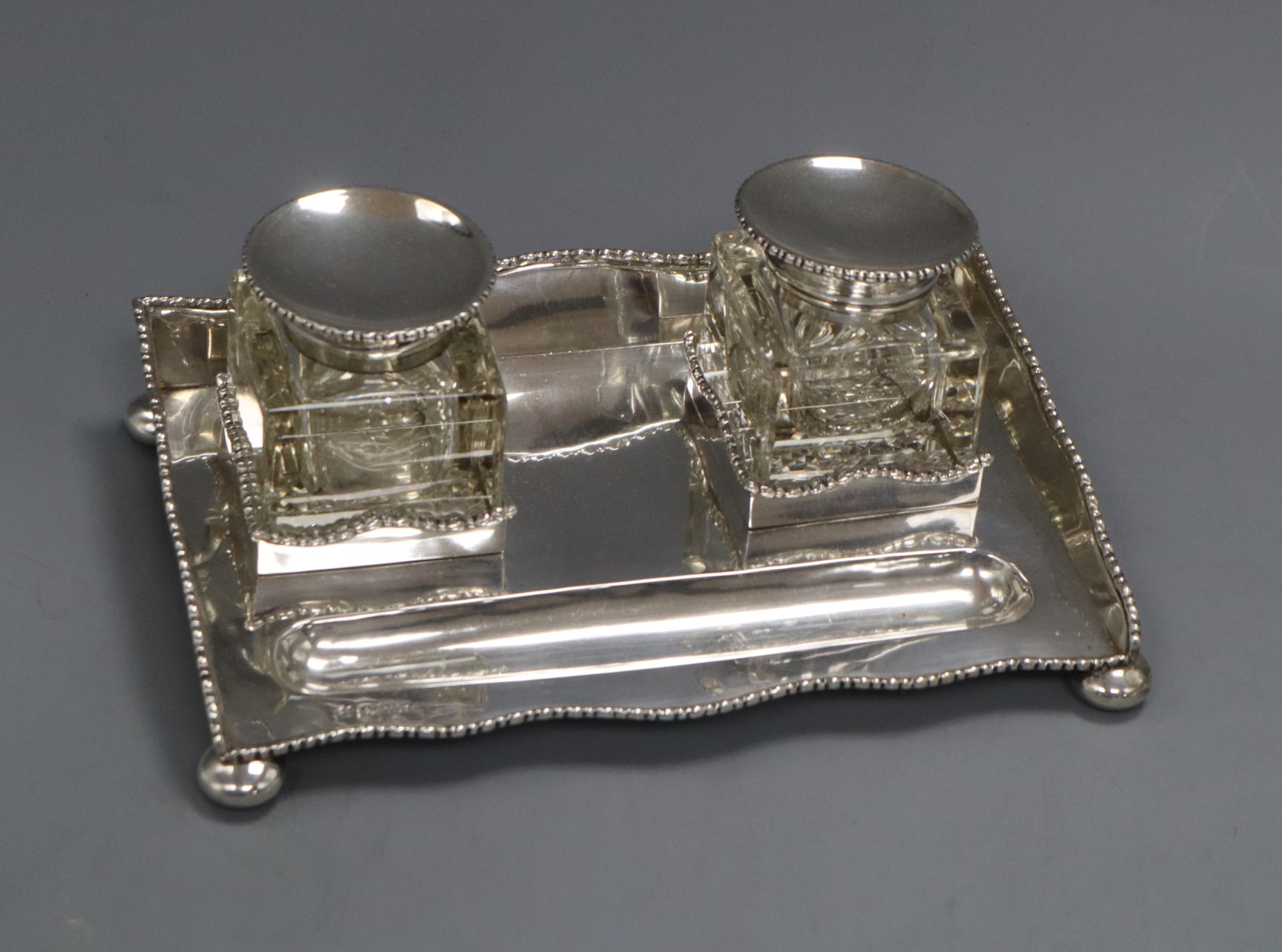 An Edwardian silver rectangular inkstand with two mounted glass wells, Nathan & Hayes, Chester,