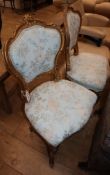 A pair of Louis XV style gilt salon chairs