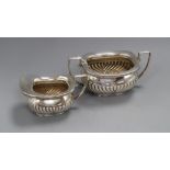 A late Victorian demi fluted silver cream jug and matching sugar bowl, William Hutton & Sons,