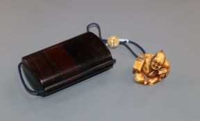 A Japanese hardwood three case inro with signed netsuke of a carpenter