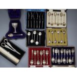 Seven cased sets/part sets of silver flatware including silver and enamel coffee spoon, a pair of