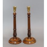 A pair of Georgian treen candlesticks, with reeded stems height 34cm