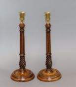 A pair of Georgian treen candlesticks, with reeded stems height 34cm