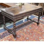 A Flemish style carved oak two drawer serving table W.130cm