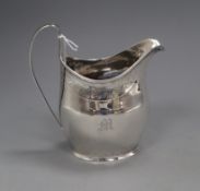 A George III silver helmet shaped cream jug by Peter, Ann & William Bateman, London, 1805, 11.6cm.