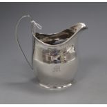 A George III silver helmet shaped cream jug by Peter, Ann & William Bateman, London, 1805, 11.6cm.