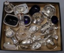 A groups of mixed white metal and mainly silver items and flatware including six condiments and