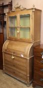 A Continental pine cylinder bureau bookcase W.103cm