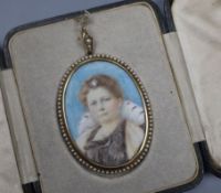 A yellow metal and seed pearl mounted oval portrait miniature of a lady, in leather case, 56mm.