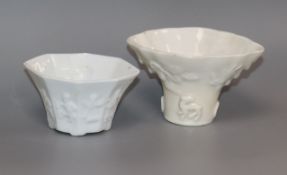 Two Chinese blanc de chine libation cups, decorated with eight figures and animals, 18th / 19th