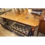 A late Victorian light oak extending dining table with two leaves