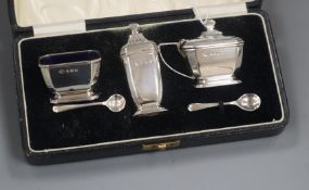 A 1930's cased three piece silver condiment set, with two spoons, by Adie Brothers.