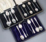 A cased set of six George V silver bean end coffee spoons and two other part cased sets of silver