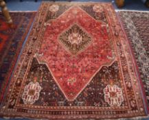 A Persian Abadeh design red, blue and ivory rug with animal and tribal motifs 240 x 170cm