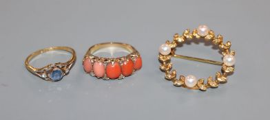 A diamond, coral and yellow metal half-hoop ring, an 18ct, sapphire and diamond ring and a pearl and