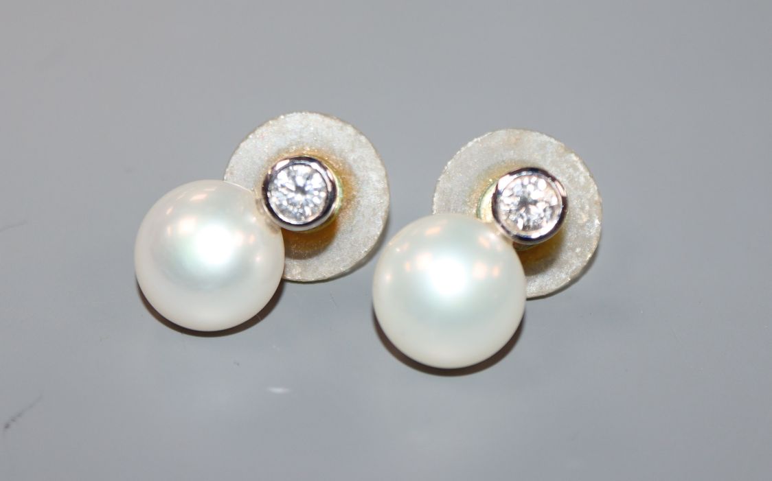 A pair of 18ct white gold, cultured pearl and diamond set ear studs, each diamond weighing