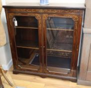 A Sheraton Revival inlaid mahogany bookcase fitted a pair of glazed doors W.106cm
