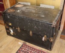 A 1920's leather and canvas covered travelling trunk / wardrobe W.105cm