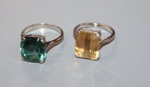 An 18ct white metal and citrine dress ring and a similar tourmaline-set ring.