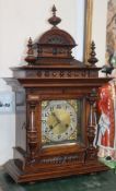 A German carved walnut mantel clock with brass dial