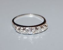 A white metal and graduated seven stone diamond half hoop ring, size O.