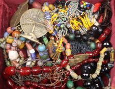 A brass inlaid rosewood box containing sundry costume jewellery including necklaces.