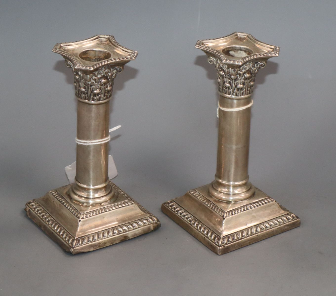 A pair of George V silver square based candlesticks, William Hutton & Sons, Sheffield 1924, 14.1cm.