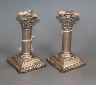 A pair of George V silver square based candlesticks, William Hutton & Sons, Sheffield 1924, 14.1cm.