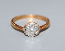 A 1920's 18ct and diamond cluster flower head ring, size R.