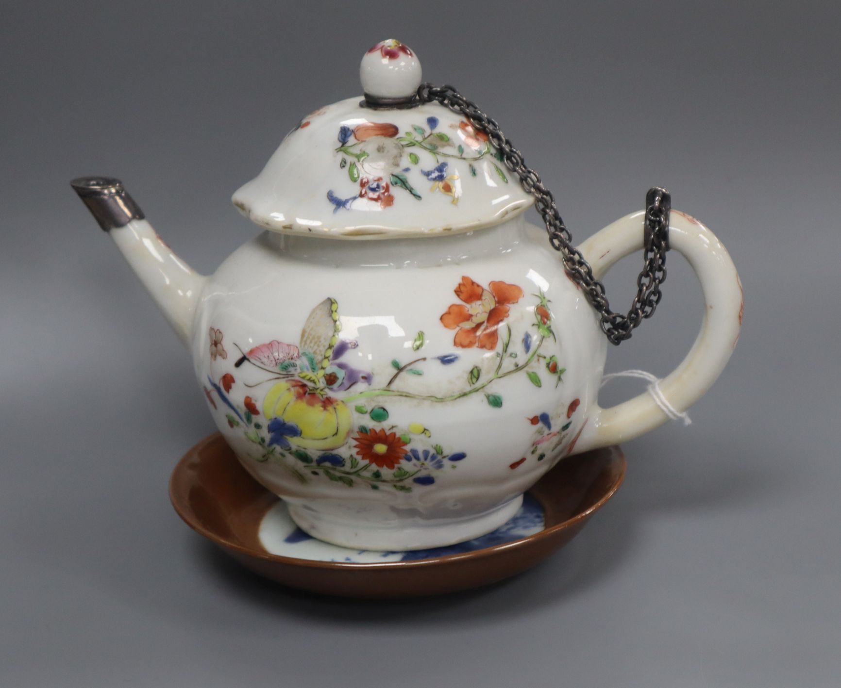 A Chinese famille rose teapot and cover, Qianlong, metal repair to spout, and a Batavia saucer