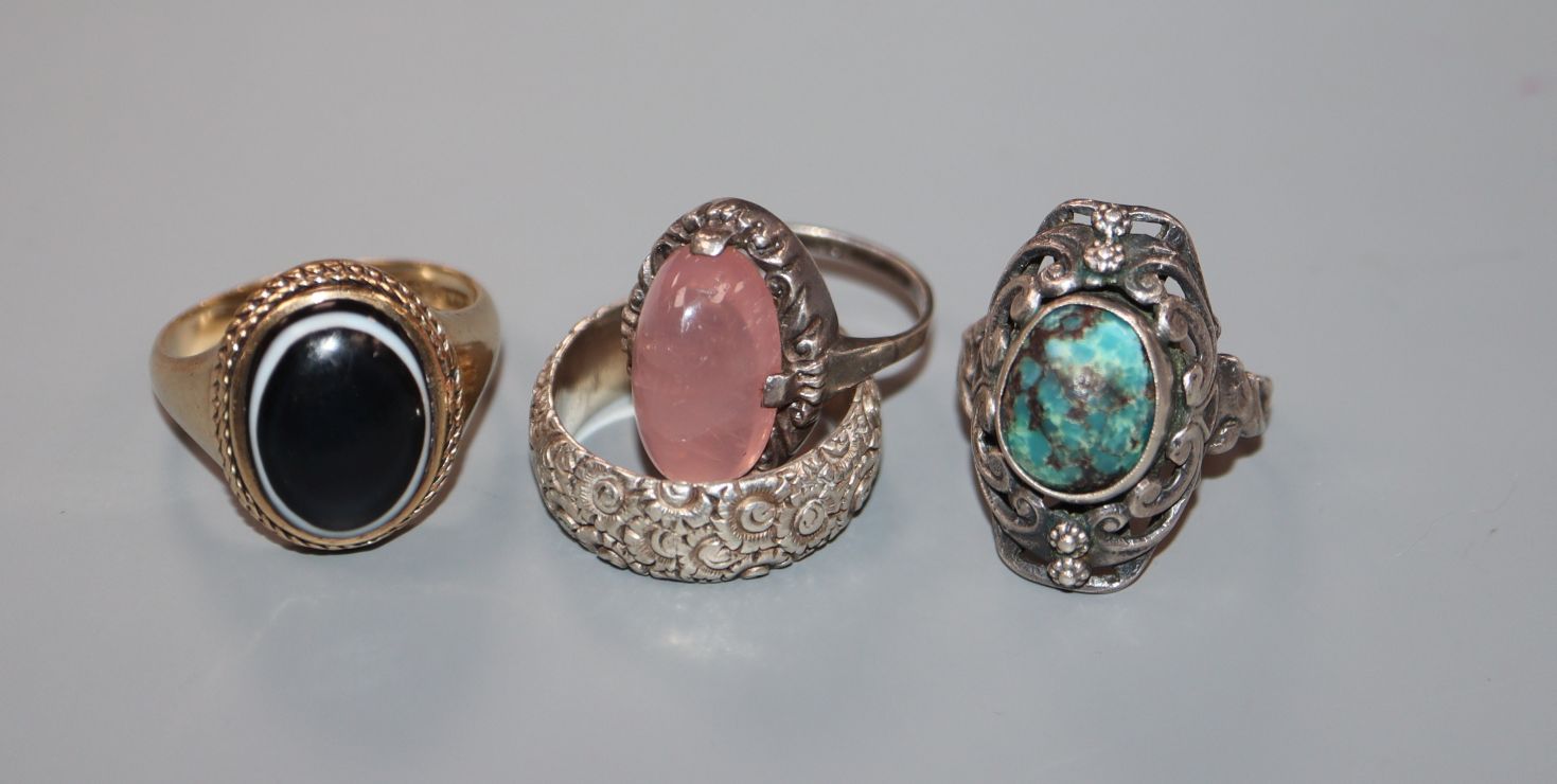 A 9ct gold and cabochon banded agate ring and three white metal rings.