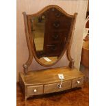 A mahogany shield shaped toilet mirror with bevelled edge