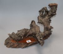 A carved rootwood sculpture on wooden base height 25cm