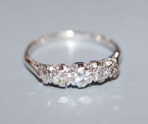 A white 18ct, plat and graduated five stone diamond half hoop ring, size L.