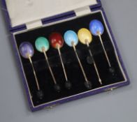 A cased set of six silver gilt and polychrome enamel bean end coffee spoons, Turner & Simpson,