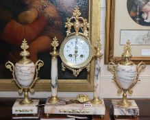 A late 19th century French pink marble and gilt metal clock garniture