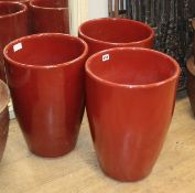 A set of three red glazed planters H.49cm
